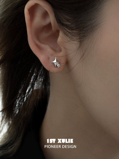 Silver cosmic star earrings elegantly worn on an ear for a stylish look