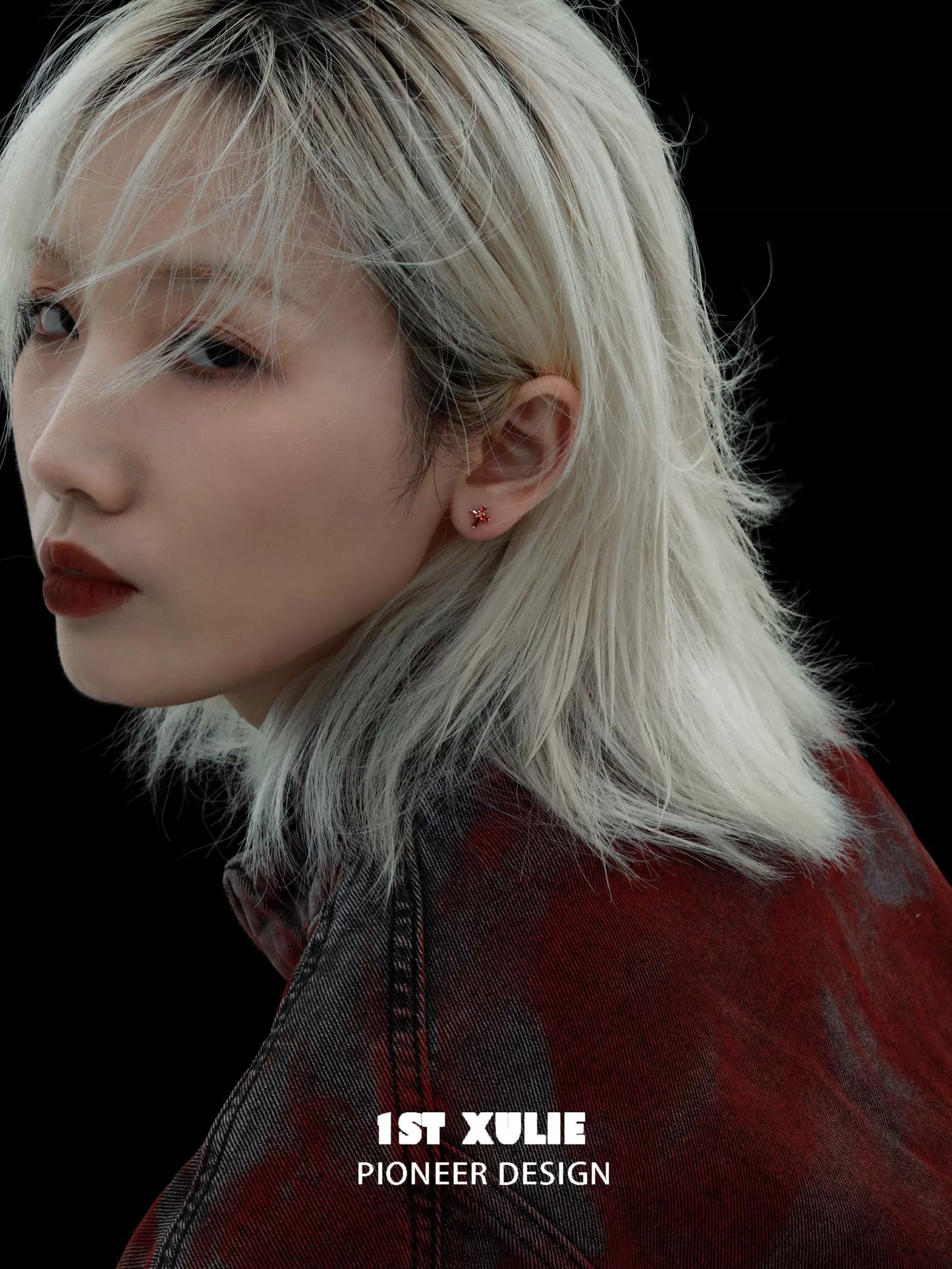Model showcasing crimson cross gothic earrings with edgy style and sleek hairstyle
