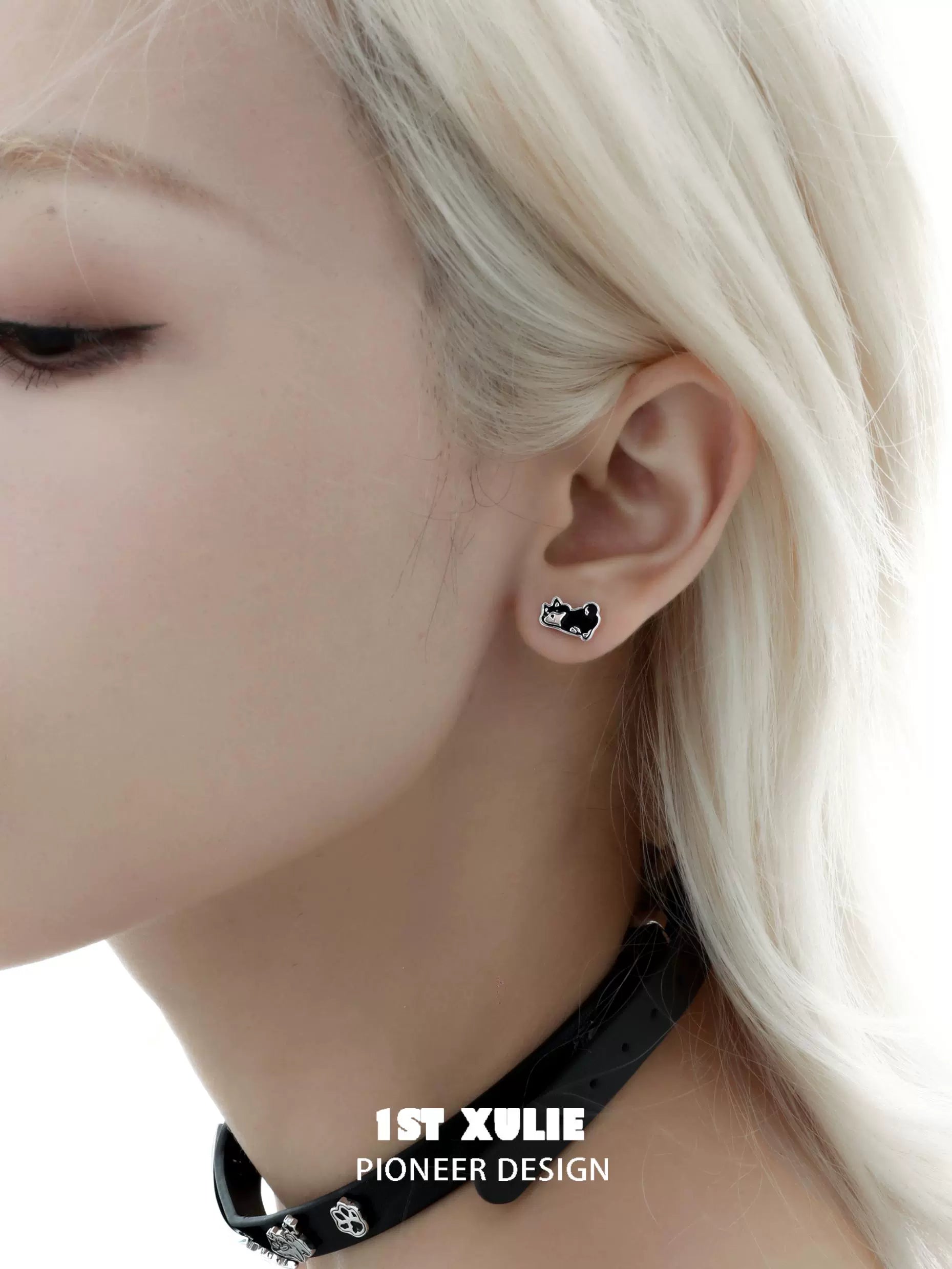 Cute puppy earrings in black design showcased on model with light hair and choker accessories