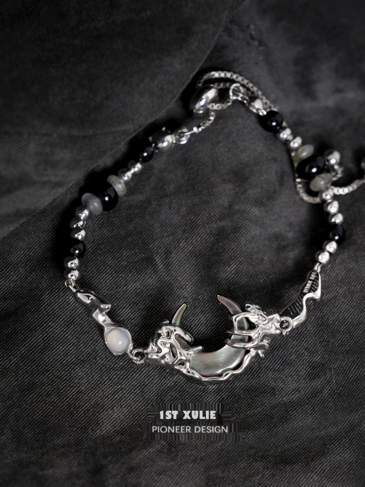 Intricate 1STXULIE dark moon agate bracelet featuring a silver moon and dragon design