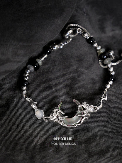 Intricate 1STXULIE dark moon agate bracelet featuring a silver moon and dragon design
