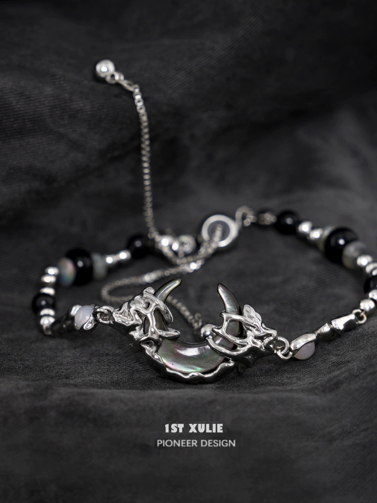 Stylish dark moon agate bracelet with silver accents and unique charm design for modern jewelry lovers