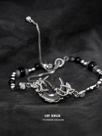 Stylish dark moon agate bracelet with silver accents and unique charm design for modern jewelry lovers