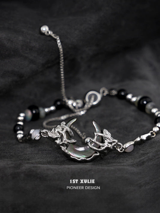 Stylish dark moon agate bracelet with silver accents and unique charm design for modern jewelry lovers