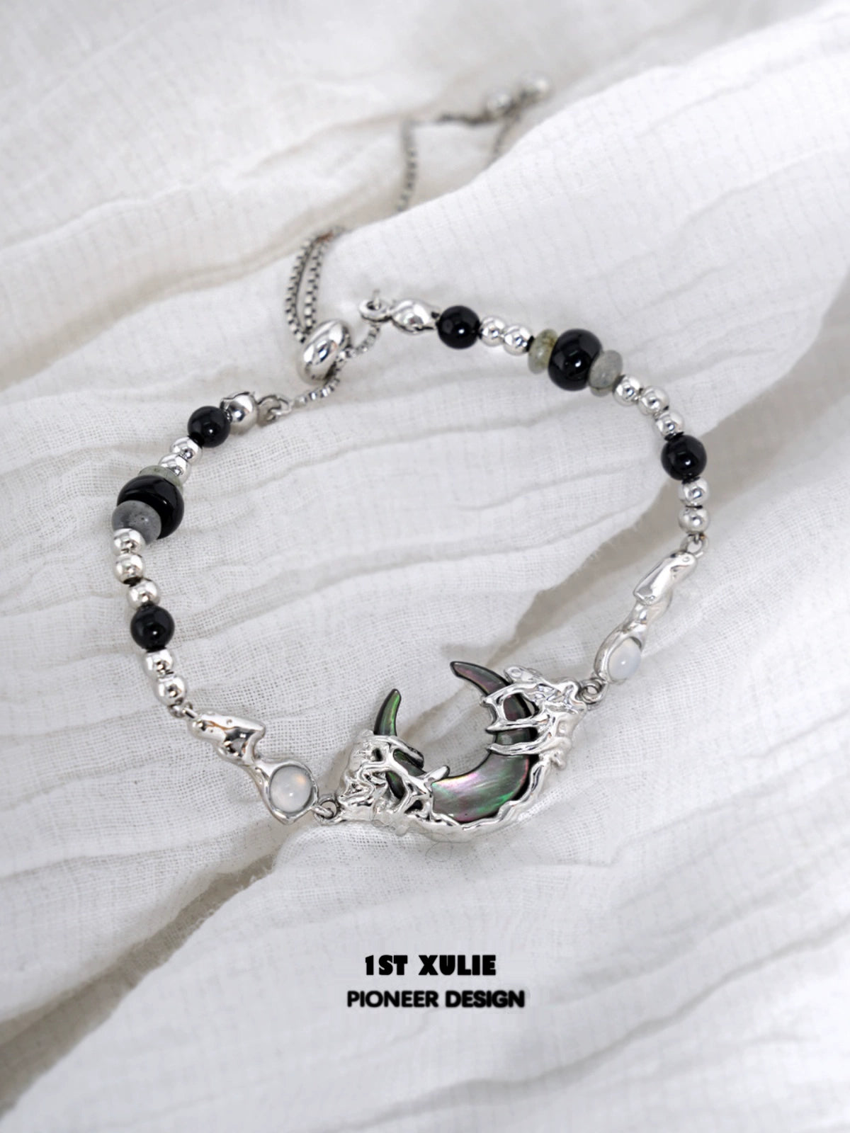 Dark moon agate bracelet with silver accents and intricate detailing for unique style