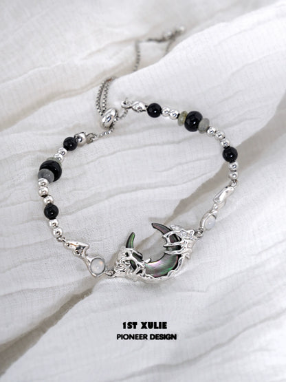 Dark moon agate bracelet with silver accents and intricate detailing for unique style
