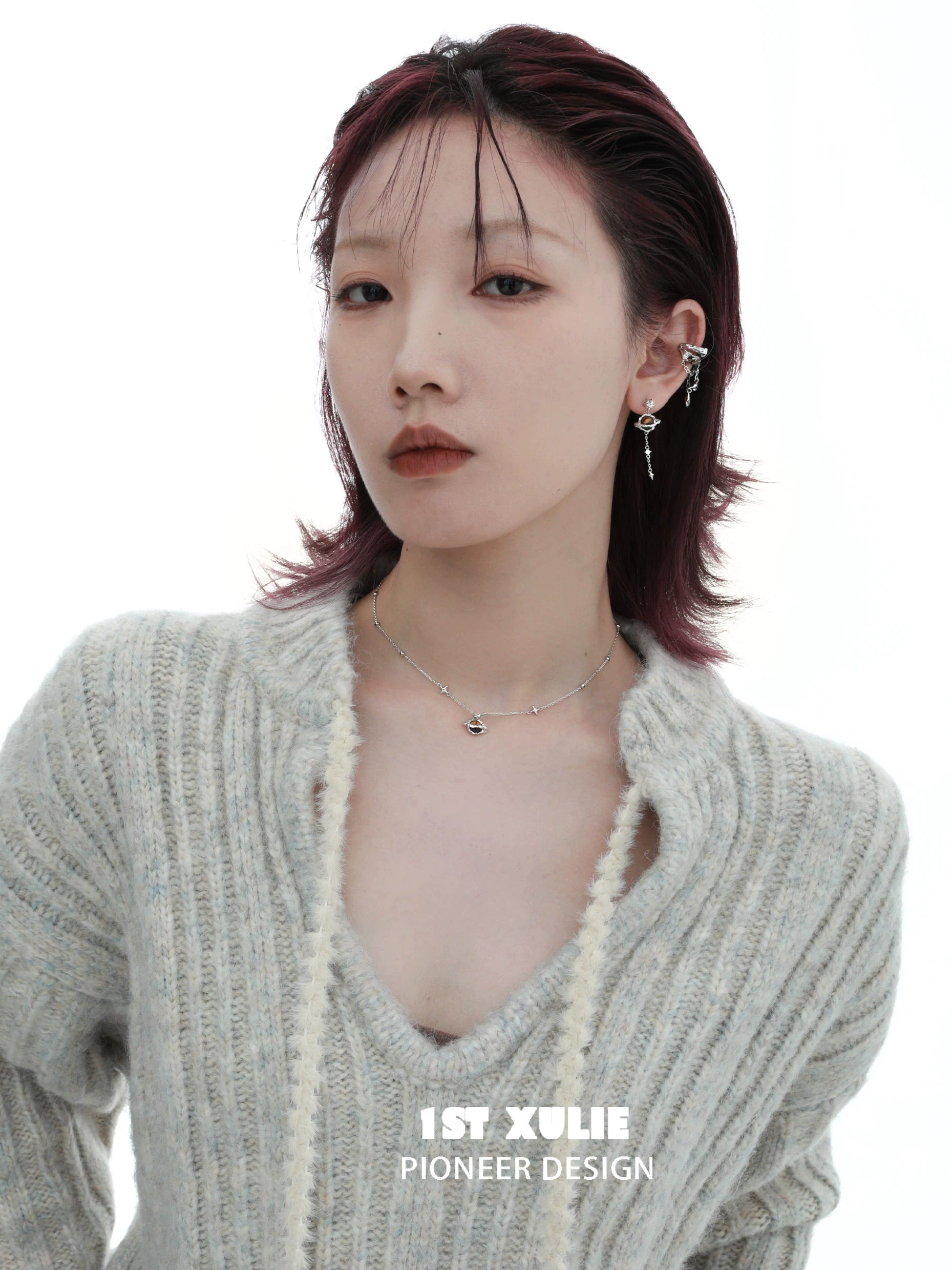 Stylish model wearing a desert planet necklace with unique design elements and modern fashion attire