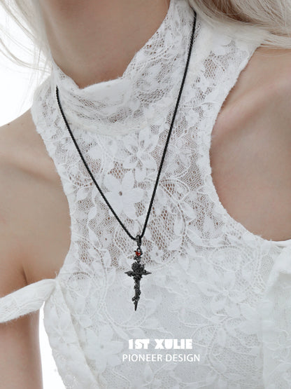 Model wearing a diablo rose cross necklace on a delicate lace top for a stylish look