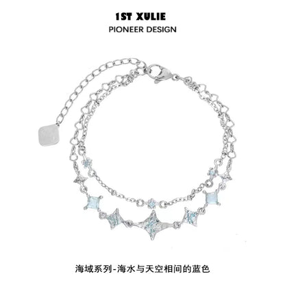 Double layer starfish silver bracelet featuring shimmering blue accents and a delicate chain design