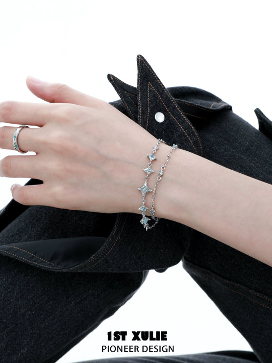 Elegant double layer starfish silver bracelet worn on a model's wrist with stylish attire