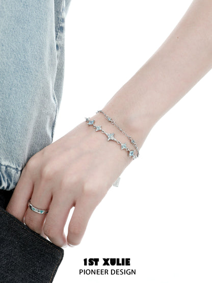 Double layer starfish silver bracelet with sparkling details worn on a wrist