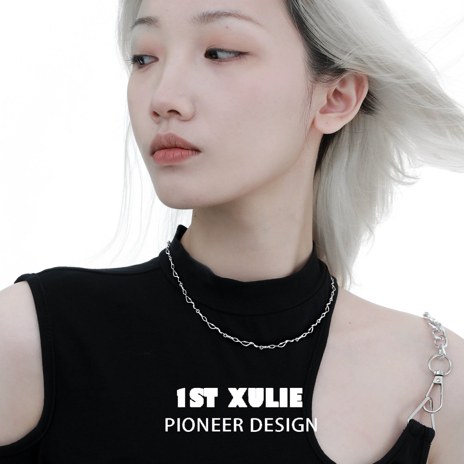 Edgy chain necklace modeled by a person wearing a black top highlighting modern fashion design