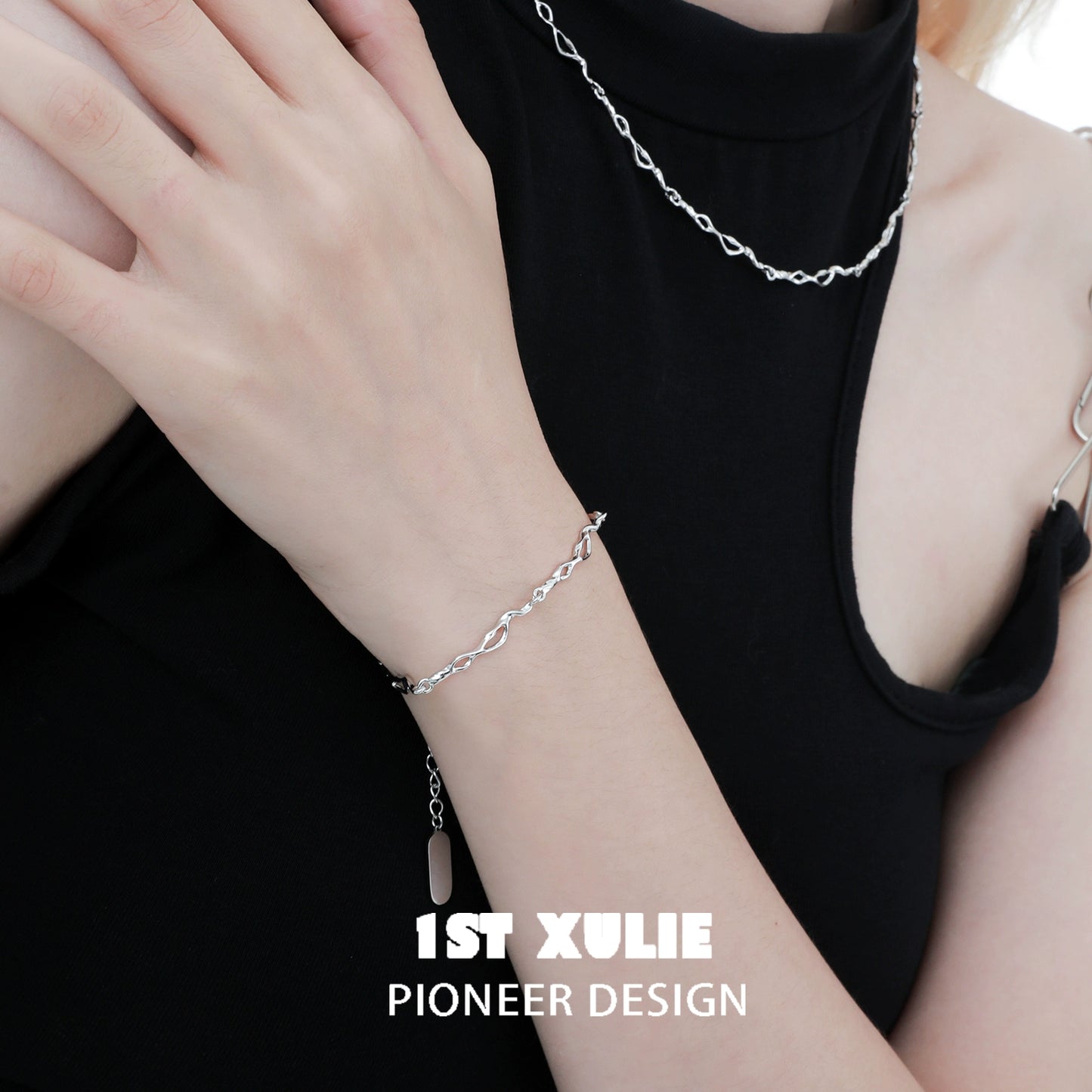 1ST XULIE Edgy chain necklace in silver paired with matching bracelet on a model's arm