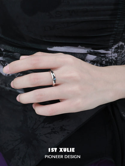 Stylish hand wearing eroded earth couple rings designed by 1STXULIE for modern couples