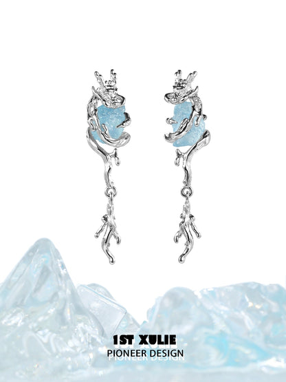 Fantasy dragon earrings with silver design and blue gemstone accents for a whimsical touch