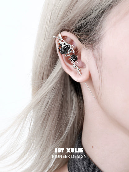 Forbidden rose ear piercing needle alongside a stylish ear cuff on a person's ear