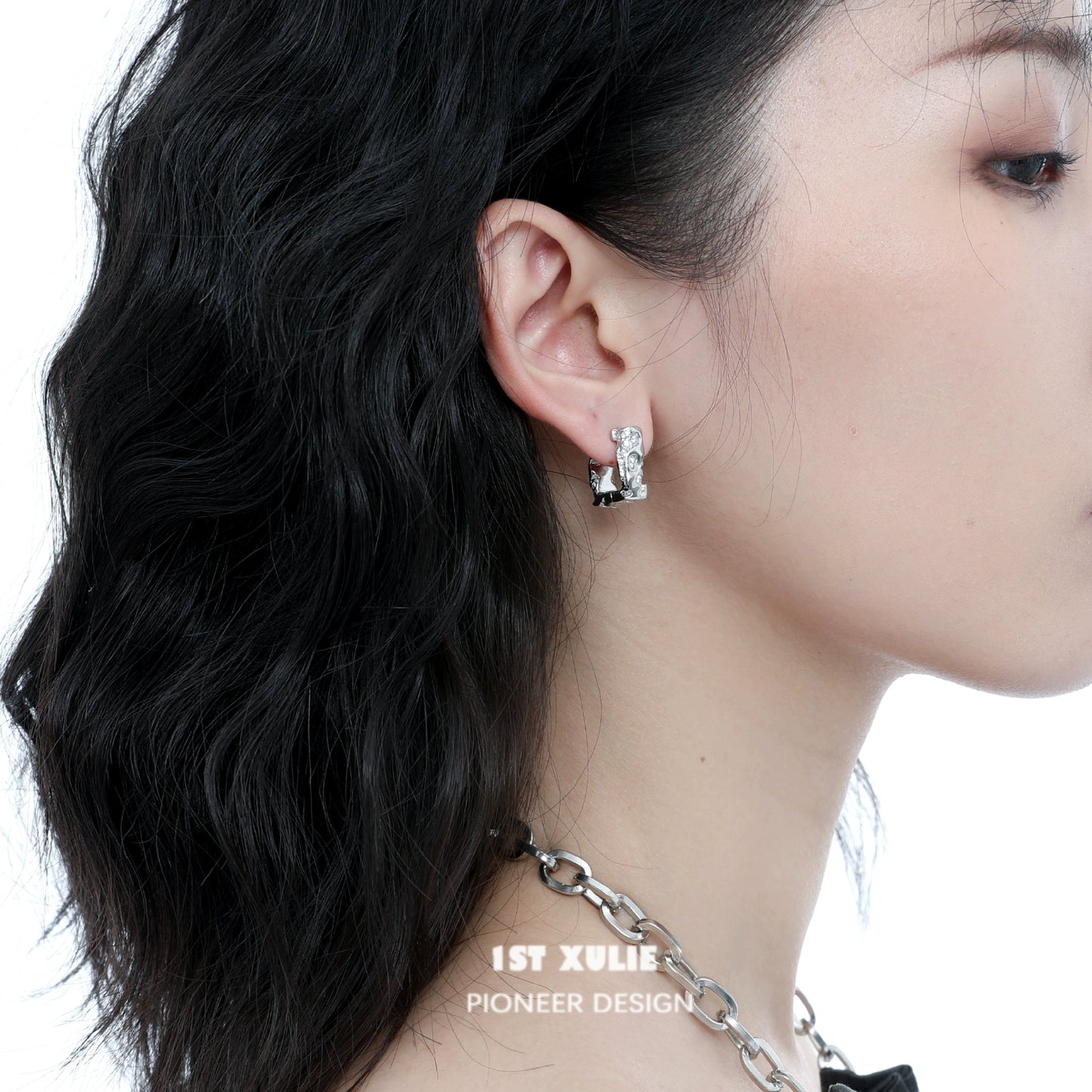 Stylish frosted geometric earrings displayed on model's ear for modern fashion look
