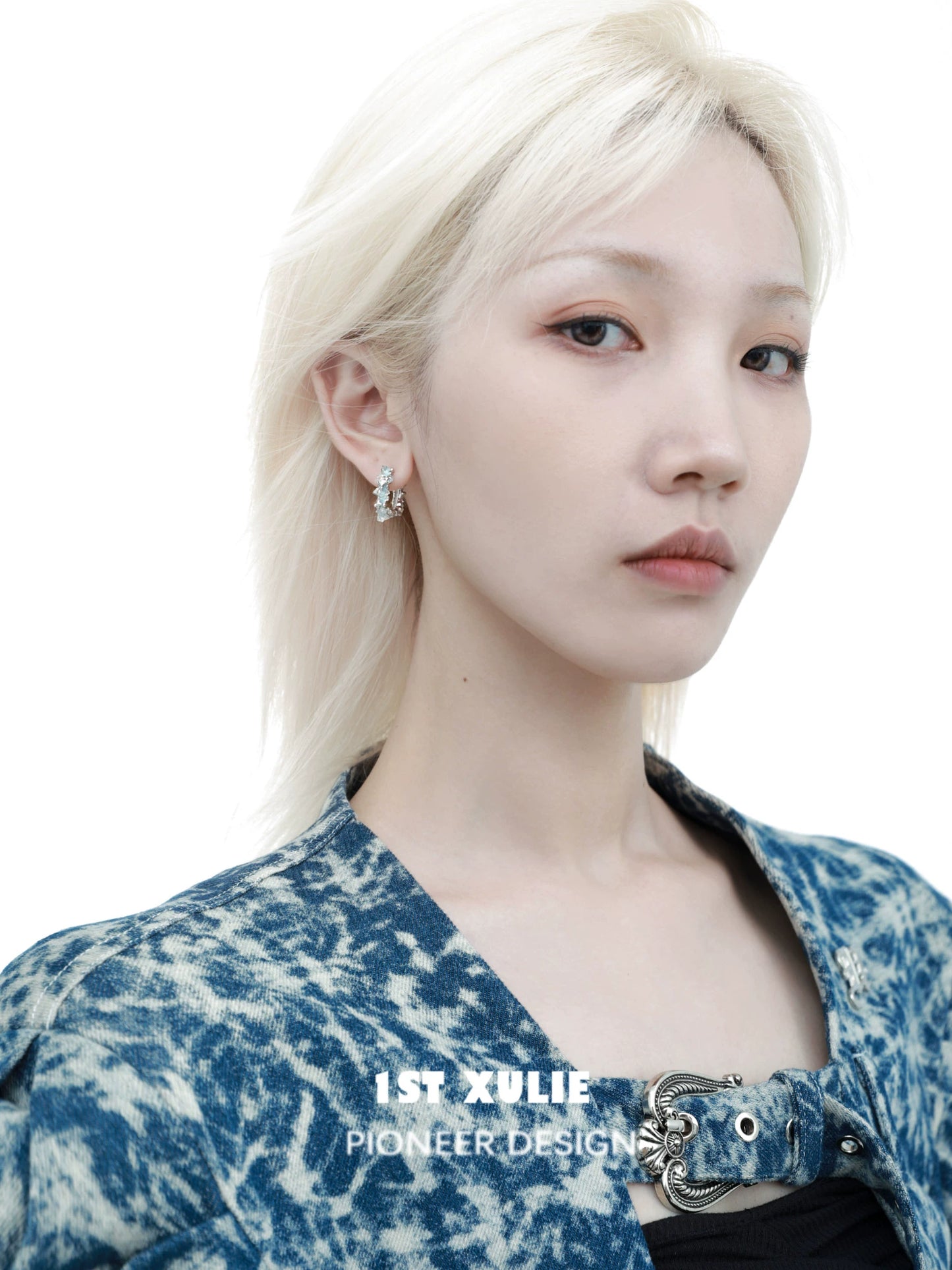 Fashion model showcasing frozen blue crystal ear cuffs for a stylish accessory look