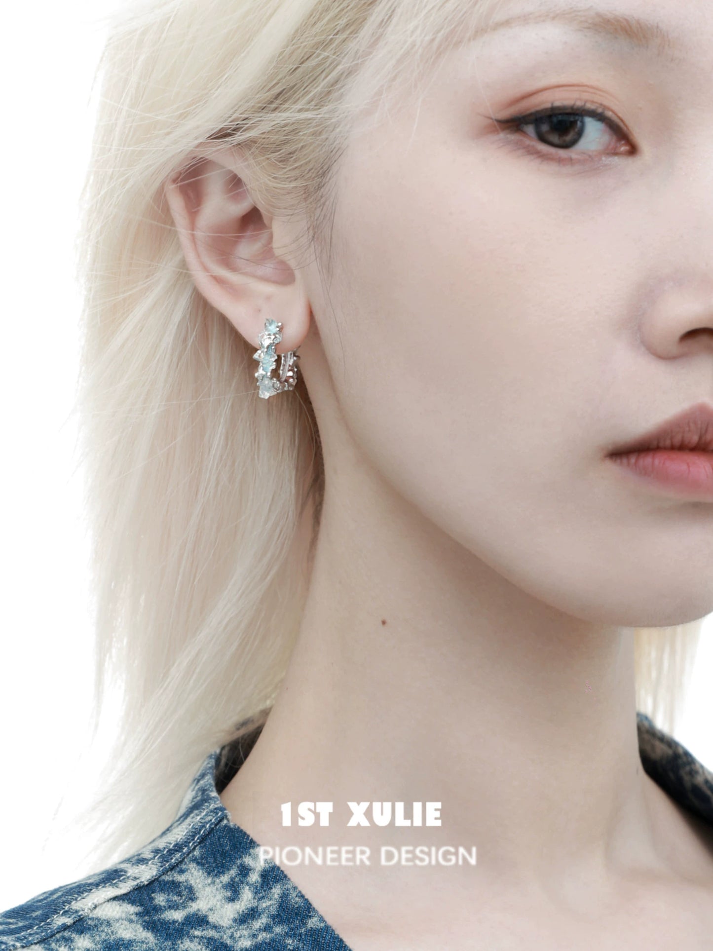 Elegant frozen blue crystal ear cuffs showcased on a model with light blonde hair