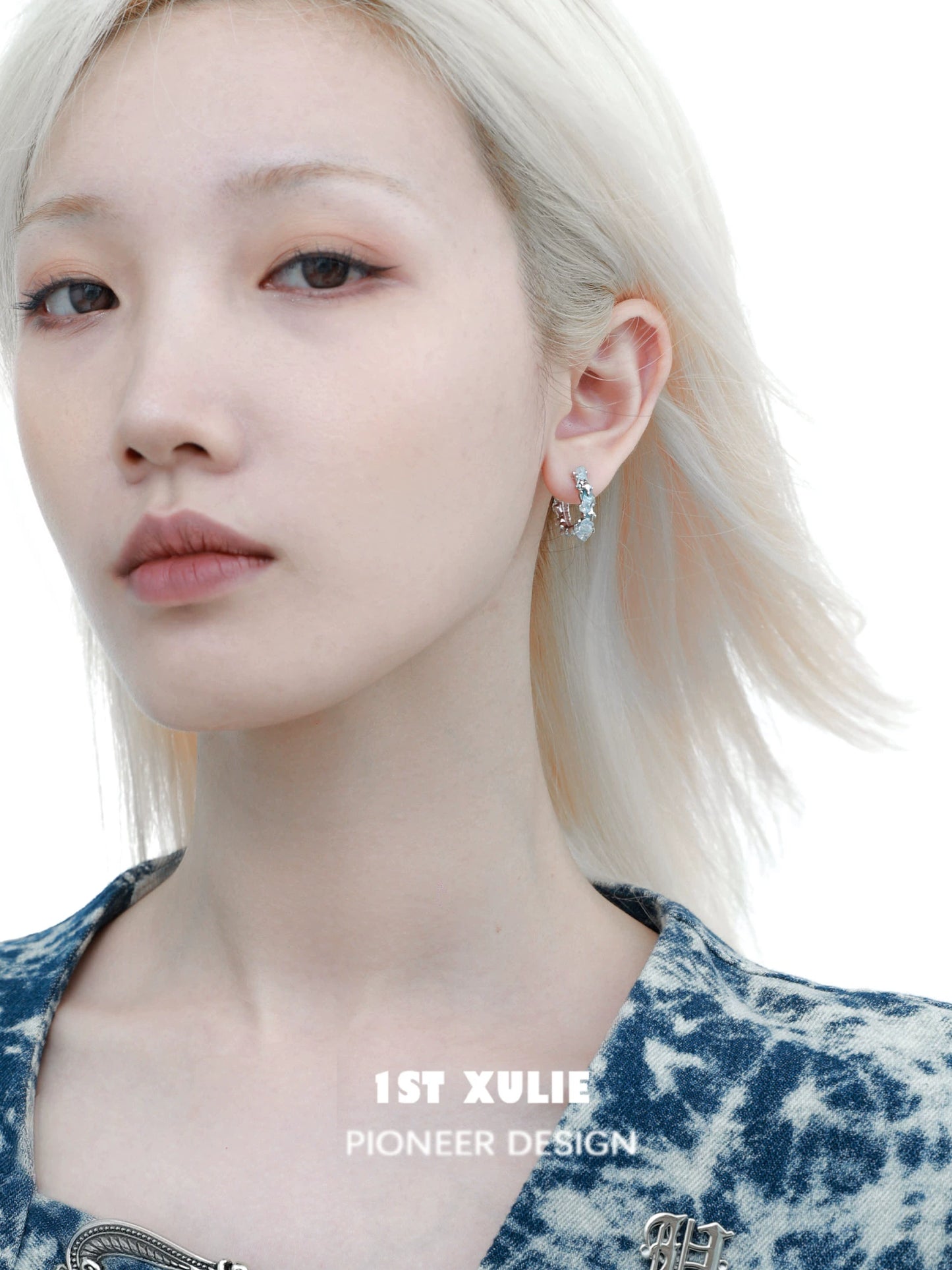 Model wearing frozen blue crystal ear cuffs designed by 1ST XULIE for a unique look
