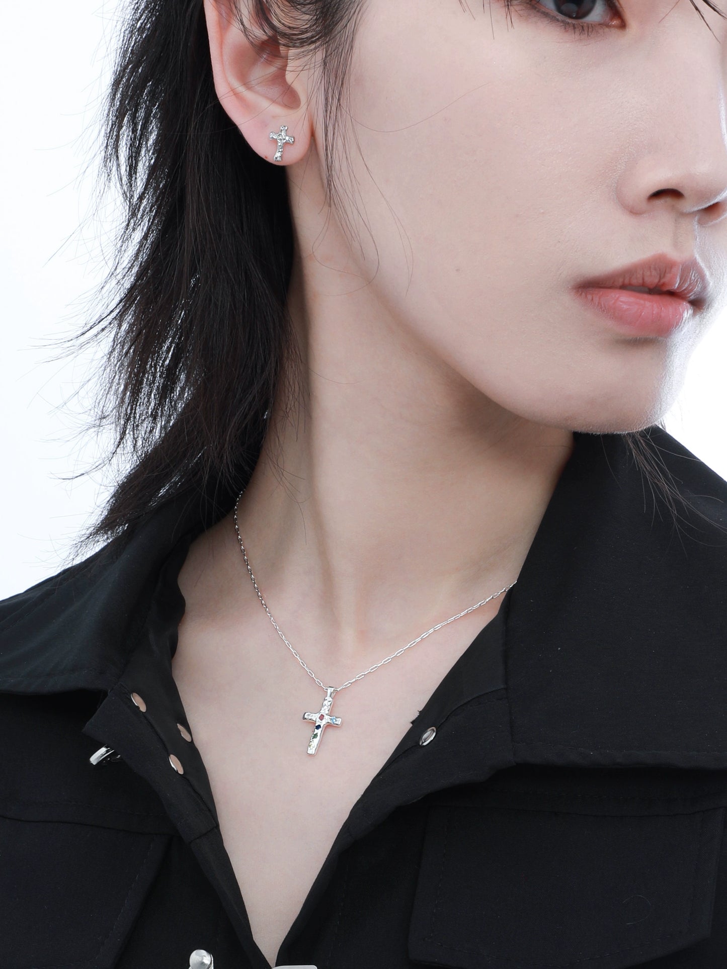 Fashionable frozen cross zircon earrings shining elegantly on a model's ear