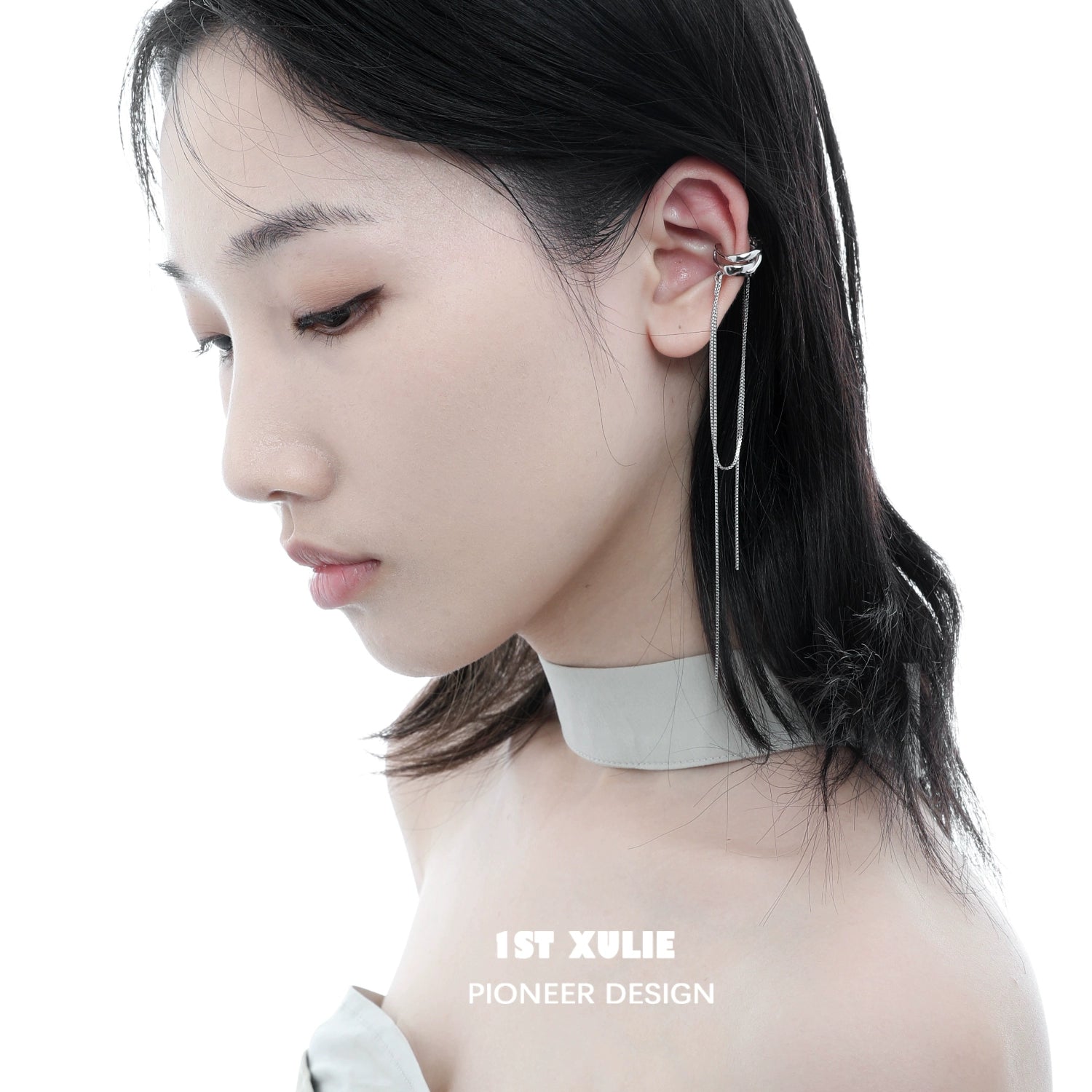 Stylish frozen tassel ear clip design worn by model with a sleek hairstyle
