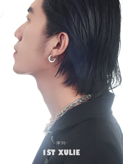Stylish model showcasing futuristic silver geometric earrings for a modern look