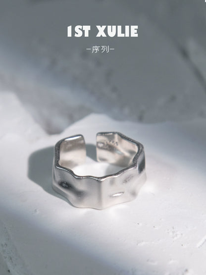 Futuristic silver ring with a unique, textured design, perfect for modern fashion enthusiasts