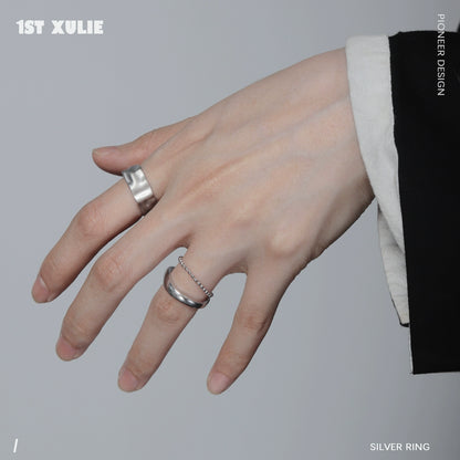 Futuristic silver ring worn on a stylish hand featuring a modern design and unique details