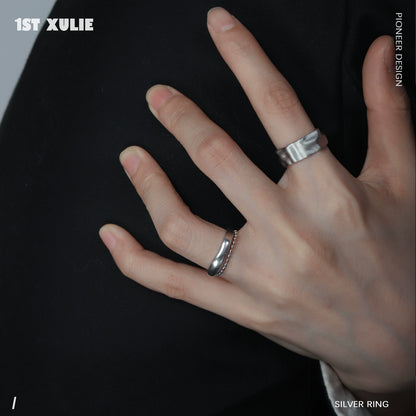 Futuristic silver ring showcased on a hand, emphasizing sleek design and modern aesthetics
