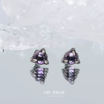 Gothic amethyst stud earrings featuring a unique design with reflective surfaces