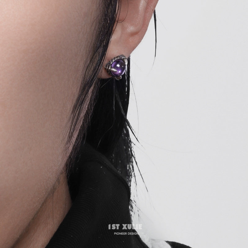 Gothic amethyst stud earrings with a unique design, perfect for a bold fashion statement