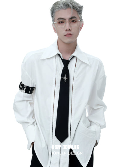 Stylish model wearing a gothic liquid metal arm bracelet with a white oversized shirt and black tie