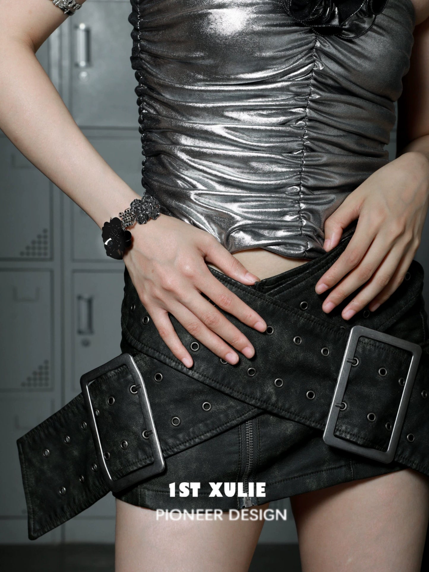 Model wearing a gothic rose bracelet paired with a silver top and black belt for a stylish look