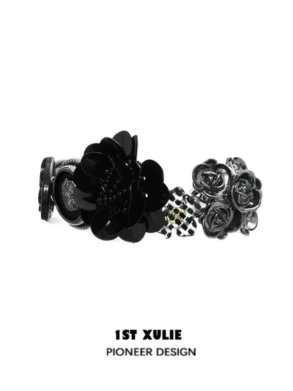 Stylish gothic rose bracelet featuring black floral designs and a unique charm