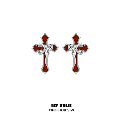 Gothic snake cross earrings in silver and red featuring intricate twisted design
