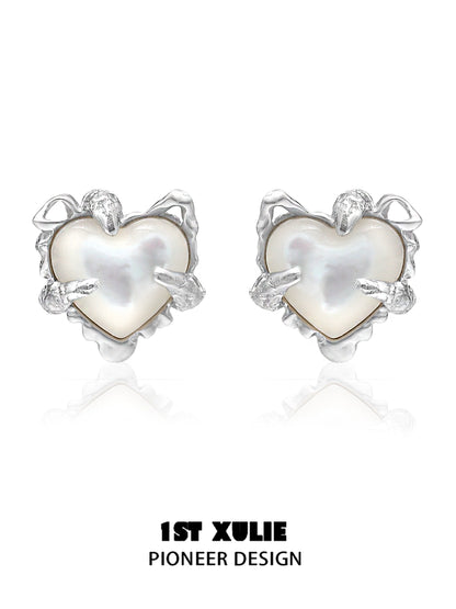 Silver heart ear clips for women with a unique pioneer design featuring a pearl center