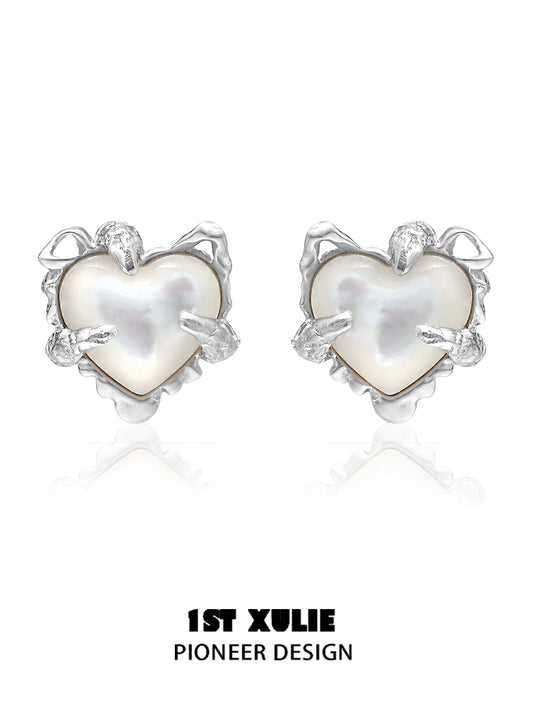Silver heart ear clips for women with a unique pioneer design featuring a pearl center