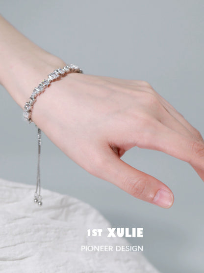 Elegant hand wearing an Iceland zircon star bracelet, showcasing its shimmering beauty and delicate design.