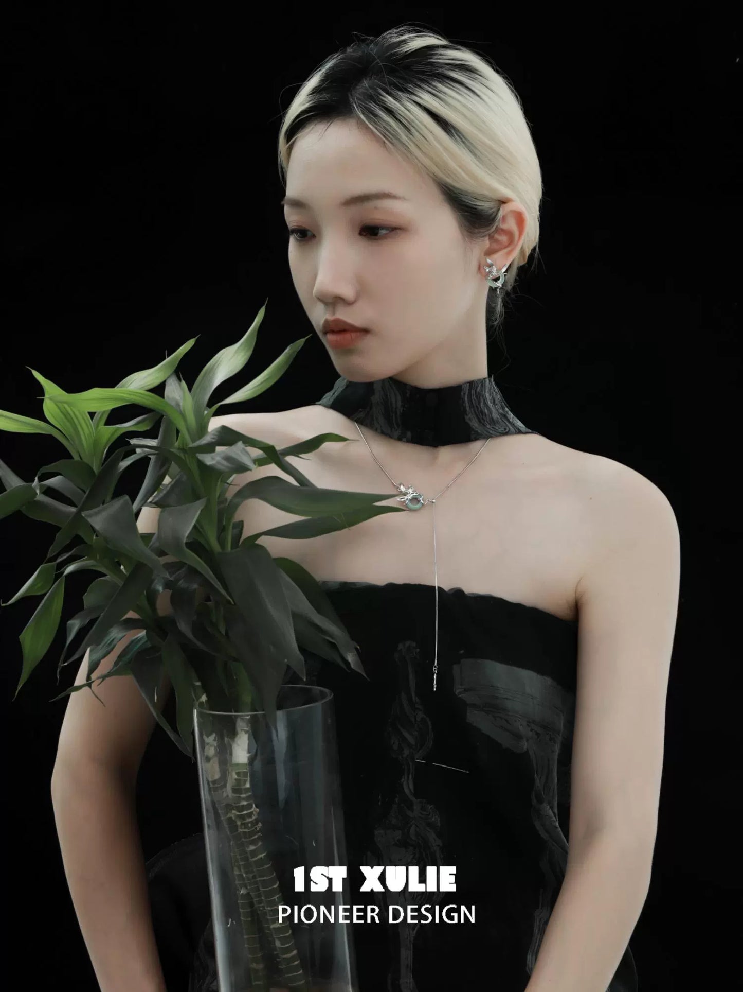 Iris silver stud earrings showcased by a model with a plant for a stylish look