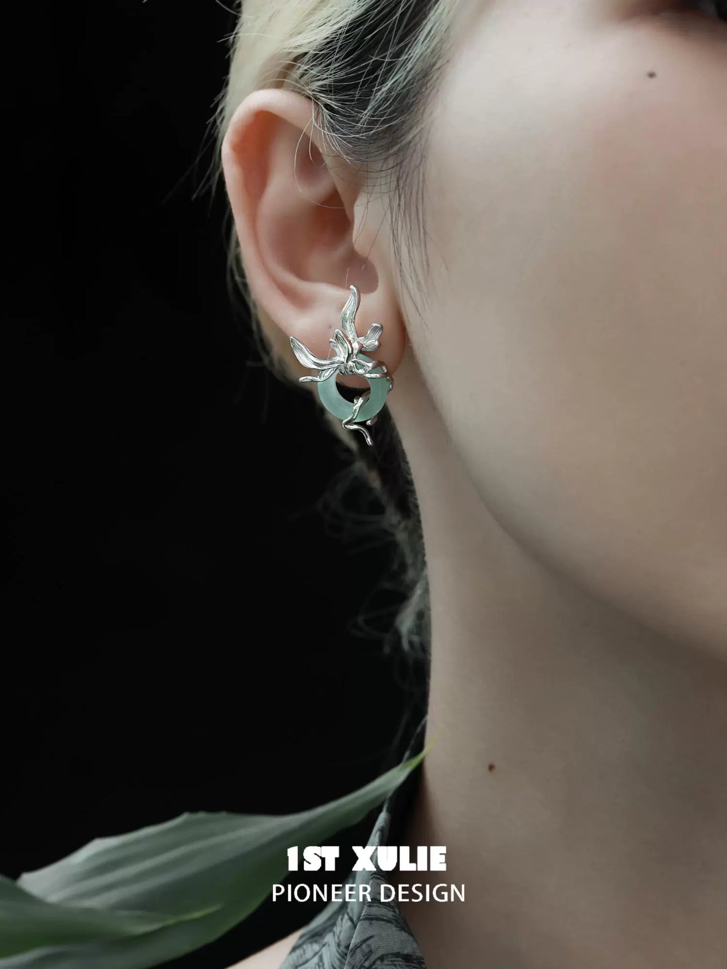 Iris silver stud earrings showcased on a model's ear with a modern design perfect for any occasion