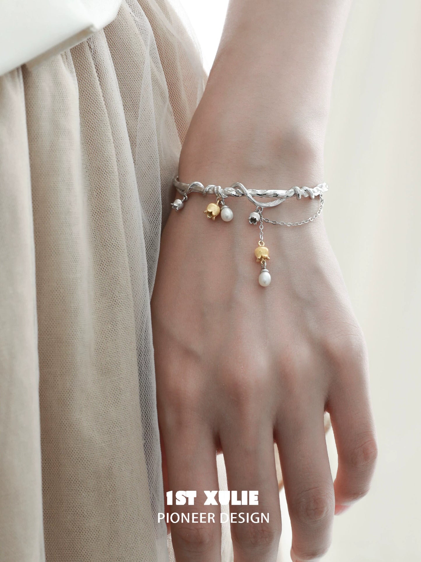 Elegant 1STXULIE lily of the valley bracelet featuring delicate pearls and gold accents