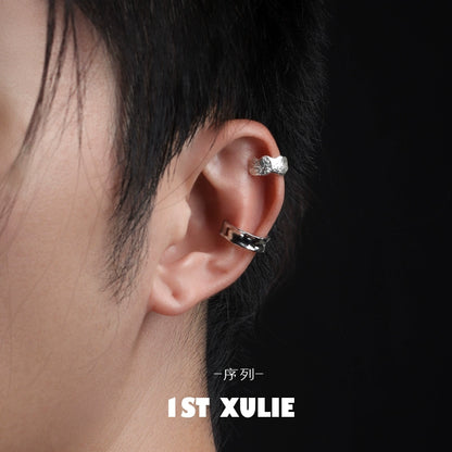 Minimalist frosted ear cuffs displayed on a model's ear showcasing sleek design and modern style