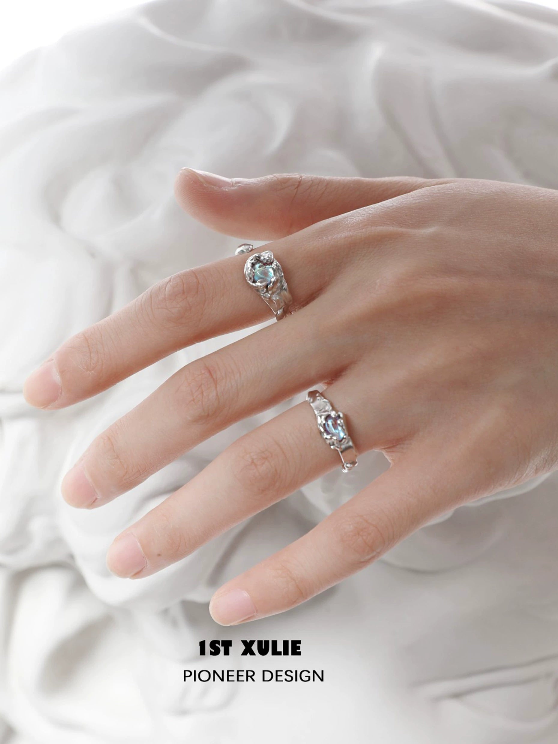 Elegant 1STXULIE moonstone silver ring displayed on a model's hand showcasing its unique design
