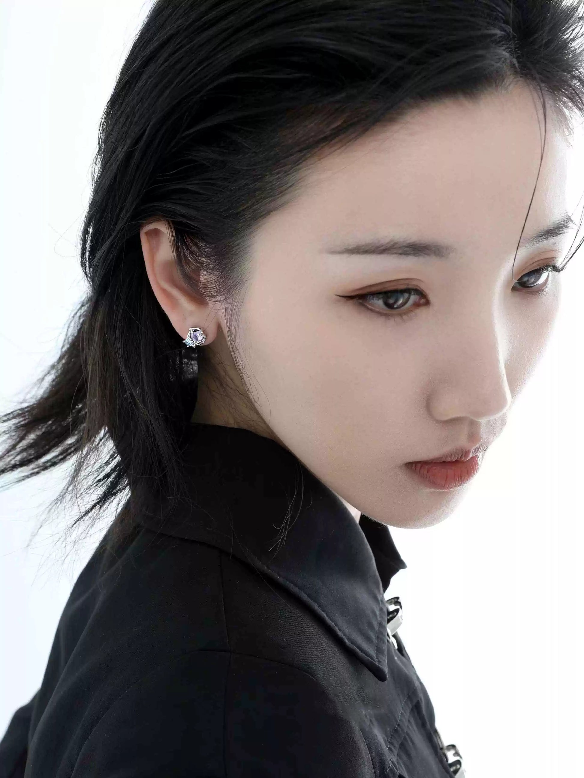 Elegant mystic amethyst zircon earrings displayed on a model with a sleek hairstyle