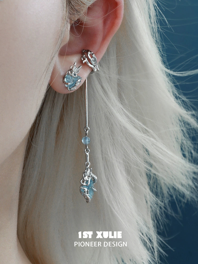 Elegant 1ST XULIE mystic elf earrings featuring shimmering blue stones and intricate silver design