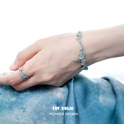 Elegant hand wearing a mystical blue silver bracelet, showcasing its unique design and craftsmanship