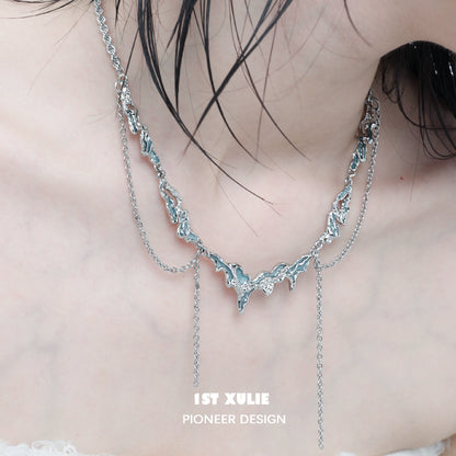 Ocean inspired tassel necklace by 1STXULIE featuring a unique wave design and delicate chains