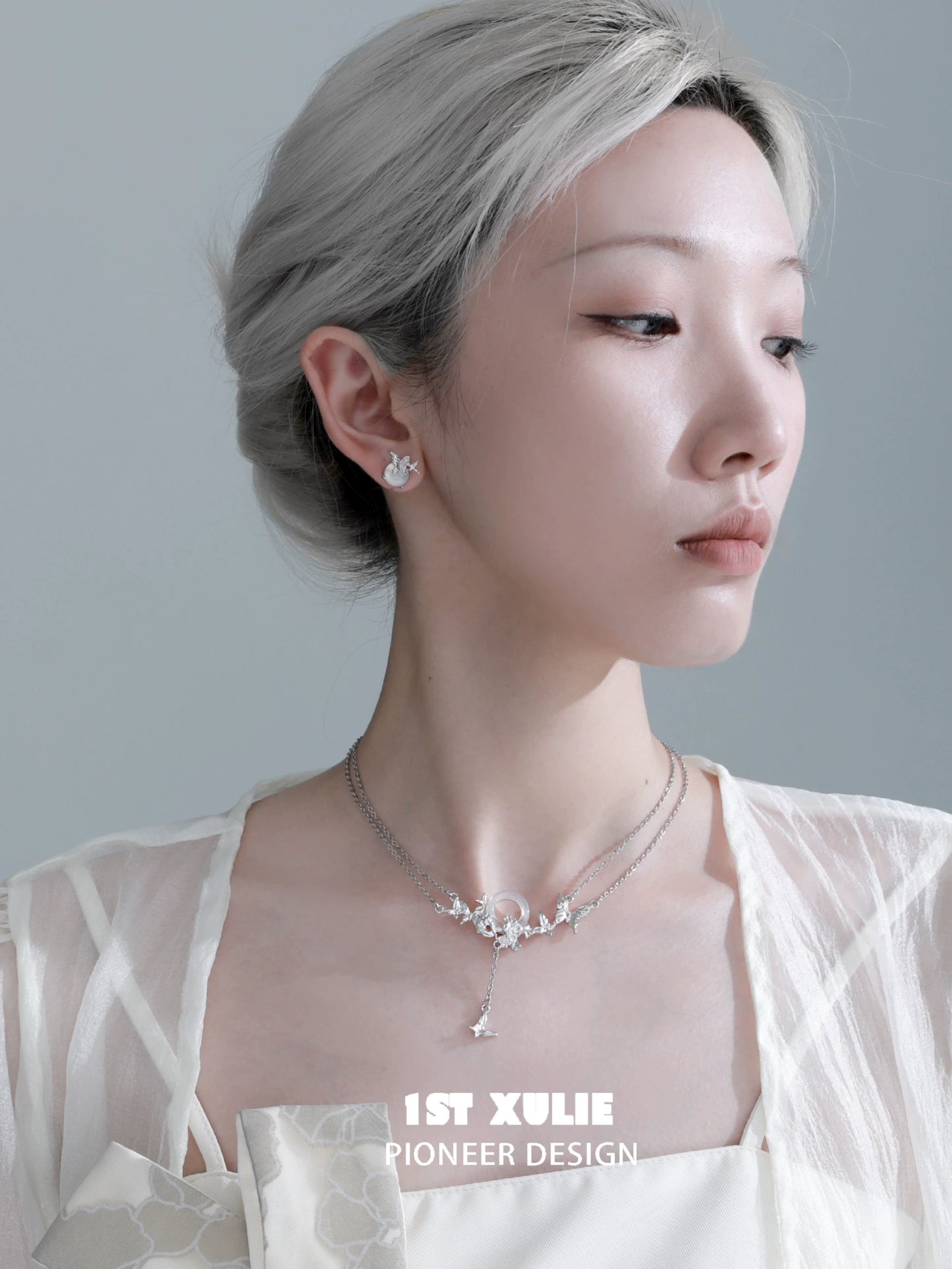 Elegant model showcasing silver butterfly stud earrings with intricate details, perfect for any occasion