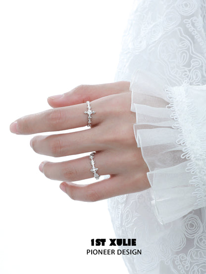 Elegant silver cross couple rings showcased on a hand with delicate lace sleeves